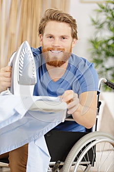 young disable man ironing