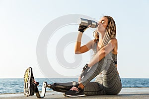 Young disabled athlete woman with prosthetic leg