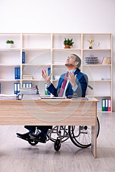 Young disabled employee working in the office