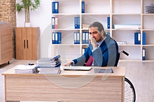 Young disabled employee working in the office