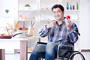 The young disabled husband preparing food salad
