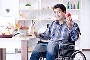 The young disabled husband preparing food salad