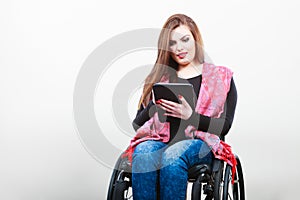 Young disabled lady with tablet.