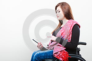 Young disabled lady with tablet.