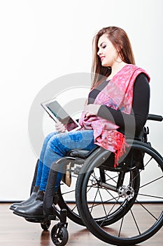 Young disabled lady with tablet.