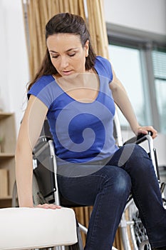 young disabled woman in wheelchair at home