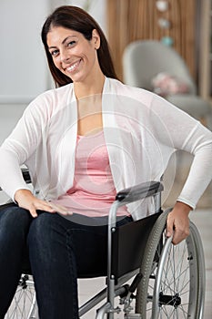 young disabled woman in wheelchair at home