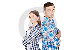 Young disconnected couple standing back to back