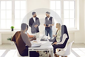 Young diverse business team having discussion during corporate meeting in office