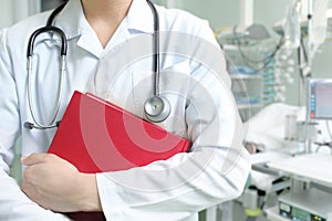 Young doctor with a book in a hospital ward