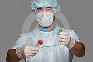 Young doctor with container for analysis