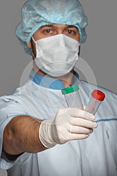 Young doctor with container for analysis