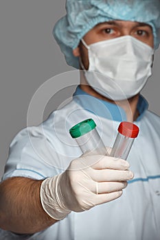 Young doctor with container for analysis