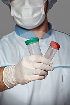 Young doctor with container for analysis