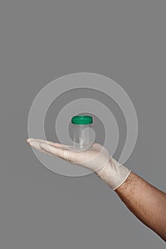 Young doctor with container for analysis