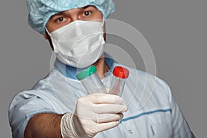 Young doctor with container for analysis