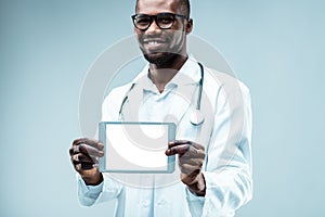 Young doctor displays digital tablet, technology aids medicine