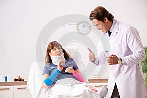 The young doctor examining injured patient