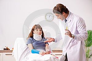 The young doctor examining injured patient