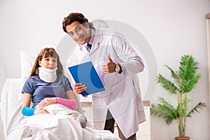 Young doctor examining injured patient