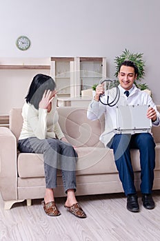 Young doctor examining senior old woman