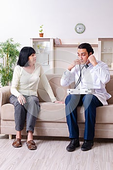 Young doctor examining senior old woman