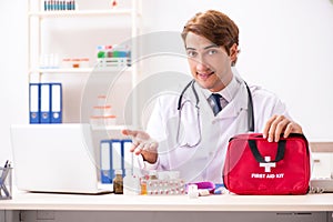 The young doctor with first aid kit in hospital