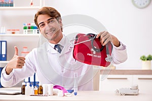 The young doctor with first aid kit in hospital