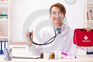 The young doctor with first aid kit in hospital