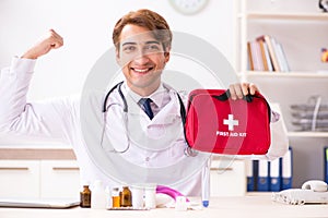 The young doctor with first aid kit in hospital