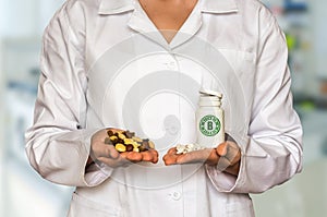 Young doctor holding nuts and bottle of pills with vitamin B com