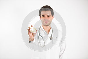 Young doctor holds tablets