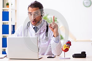 Young doctor listening to patient during telemedicine session