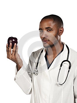 Young doctor looking at an apple