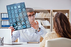 The young doctor looking at computer tomography x-ray image