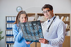 The young doctor looking at computer tomography x-ray image