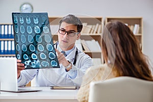 The young doctor looking at computer tomography x-ray image