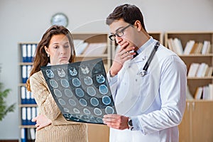 The young doctor looking at computer tomography x-ray image