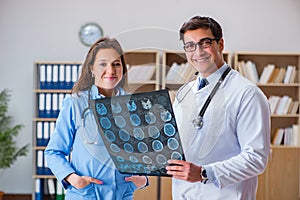 The young doctor looking at computer tomography x-ray image