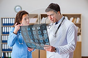 The young doctor looking at computer tomography x-ray image