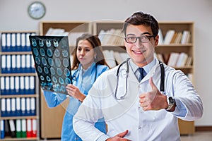 The young doctor looking at computer tomography x-ray image