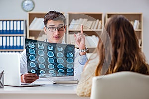 The young doctor looking at computer tomography x-ray image