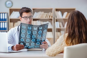 The young doctor looking at computer tomography x-ray image