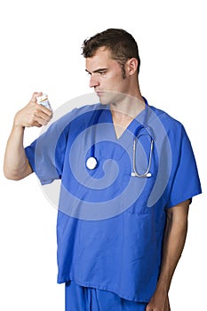 Young Doctor looking at pill bottle