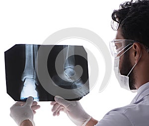 Young doctor looking at x-ray images isolated on white