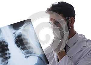 Young doctor looking at x-ray images isolated on white