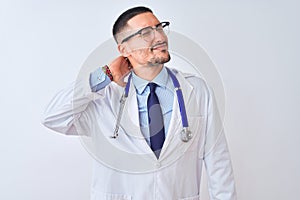 Young doctor man wearing stethoscope over isolated background Suffering of neck ache injury, touching neck with hand, muscular