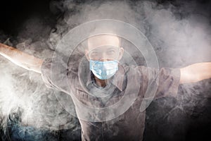 Young doctor in a mask in smoke