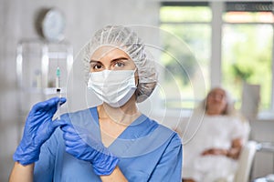 Young doctor with mask and syringe