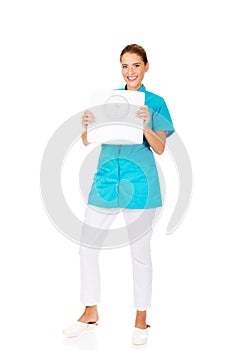 Young doctor or nurse holding weight